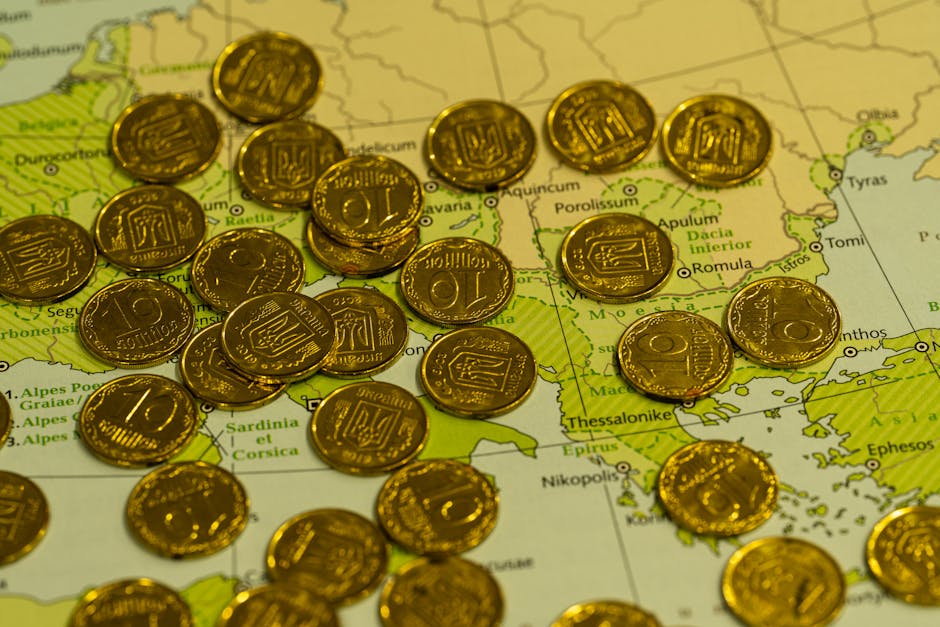 Three stacks of Euro coins of varying heights placed on a map of Dalmatia over Split, Hvar, and Dubrovnik, visually representing the tax differences by destination.