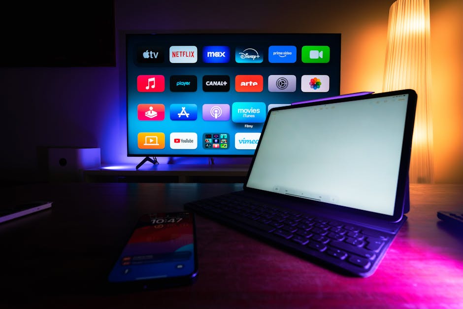 Several electronic devices—a laptop, tablet, and smartphones—active on a table, showing a heavy load on an apartment's WiFi network.